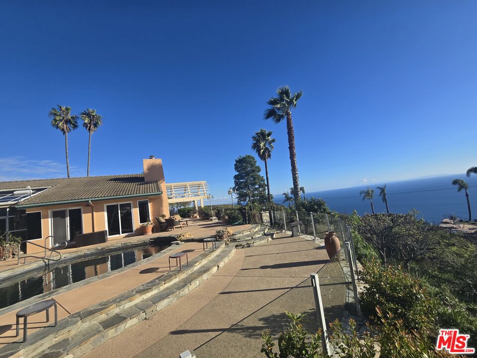 20776 Big Rock Drive Malibu, CA 90265 - Photo 8 of 67 a view of a patio with a table and chairs