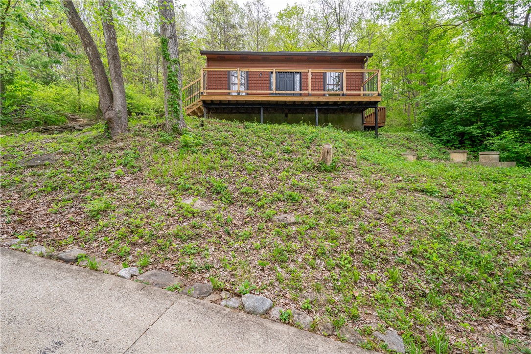 10584 New Biddinger Road Harrison, OH 45030 - Photo 48 of 61 Perched amidst lush greenery, this elevated home offers a private deck and natural surroundings.