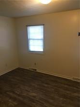 339 Balsinger Road McClellandtown, PA 15458 - Photo 5 of 9 an empty room with wooden floor and windows