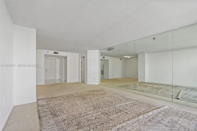a view of a hallway with closet and cabinet