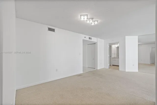 a spacious bathroom with a shower a sink and a mirror