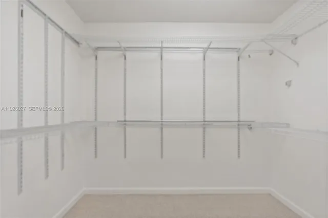 a group of lawn chairs under an umbrella