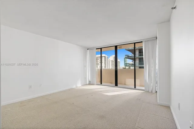 a living room with furniture and a baby crib