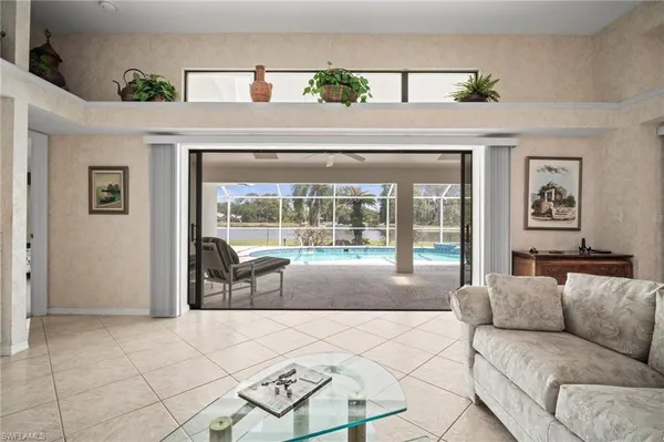 a living room with a large window and a table
