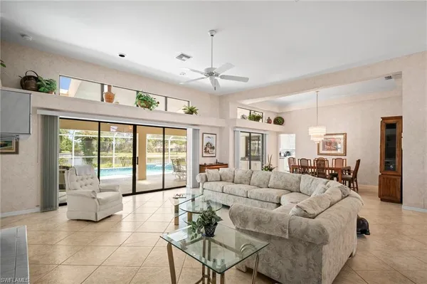 a living room with furniture and large windows
