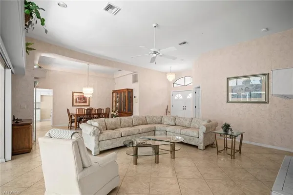 a living room with furniture and a chandelier