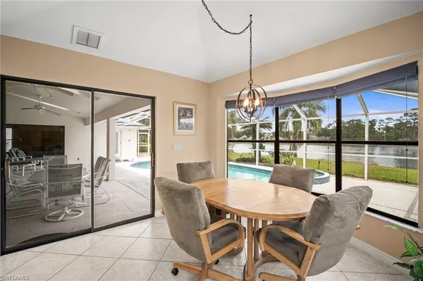 a dining room with furniture a chandelier and fireplace