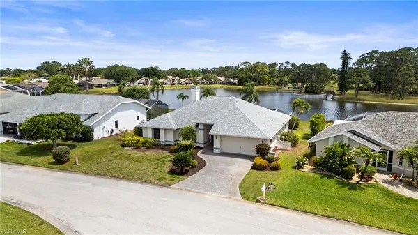 an aerial view of a house with a garden and lake view
