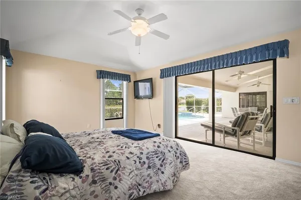 a bedroom with a large bed and a large window with the outer view