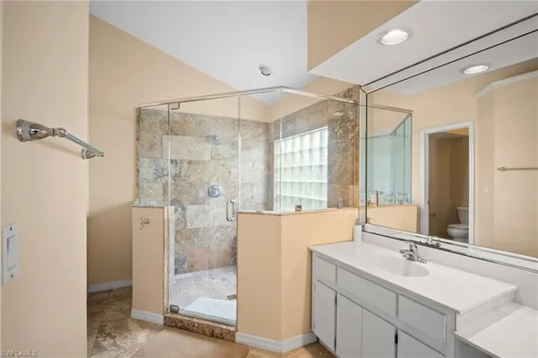a bathroom with a double vanity sink mirror and shower
