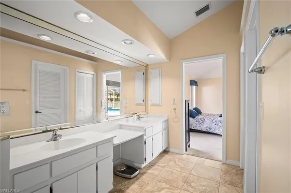 a spacious bathroom with a double vanity sink mirror and
