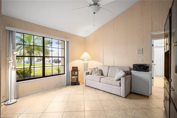 a living room with furniture and large windows