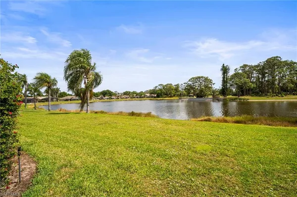 a view of a lake with houses in the back