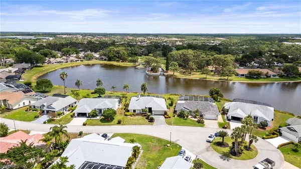 an aerial view of a house with a lake view