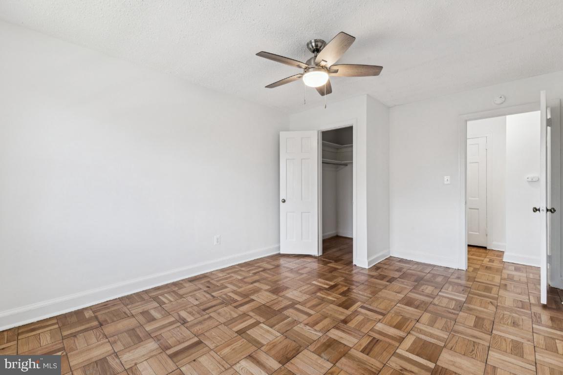 1620 West Abingdon Drive, Unit 301 Alexandria, VA 22314 - Photo 15 of 24 a view of a livingroom with a chandelier fan and wooden floor