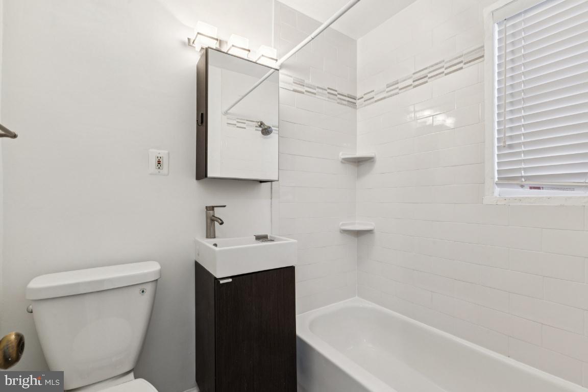 1620 West Abingdon Drive, Unit 301 Alexandria, VA 22314 - Photo 16 of 24 a bathroom with a sink toilet and shower