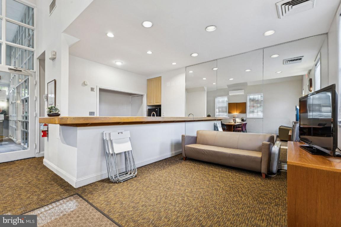 1620 West Abingdon Drive, Unit 301 Alexandria, VA 22314 - Photo 20 of 24 a living room with furniture and a flat screen tv