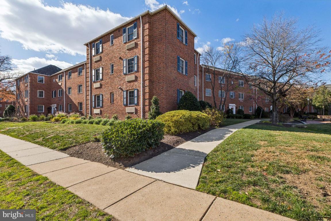 1620 West Abingdon Drive, Unit 301 Alexandria, VA 22314 - Photo 2 of 24 a view of a building with a yard