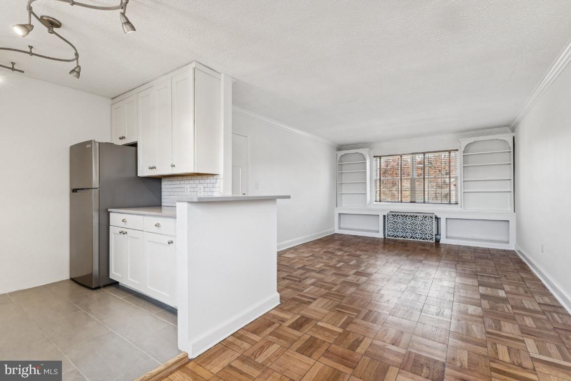 1620 West Abingdon Drive, Unit 301 Alexandria, VA 22314 - Photo 7 of 24 a view of kitchen with windows and refrigerator