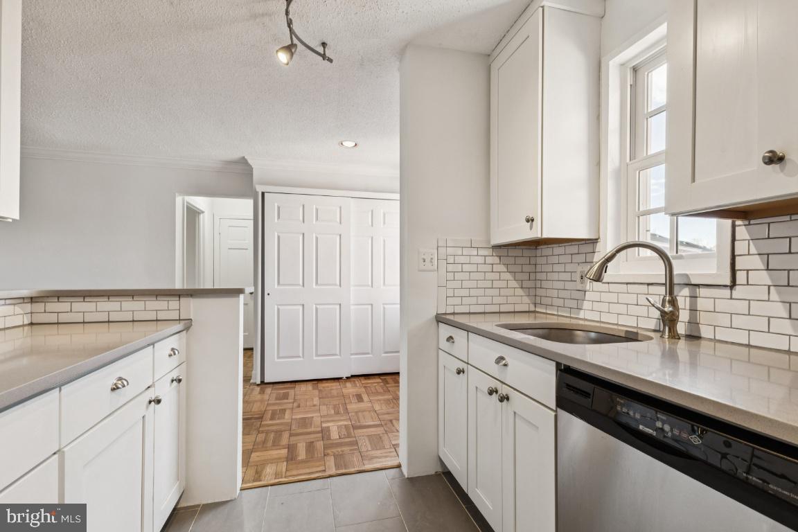 1620 West Abingdon Drive, Unit 301 Alexandria, VA 22314 - Photo 8 of 24 a kitchen with stainless steel appliances granite countertop a sink stove and cabinets