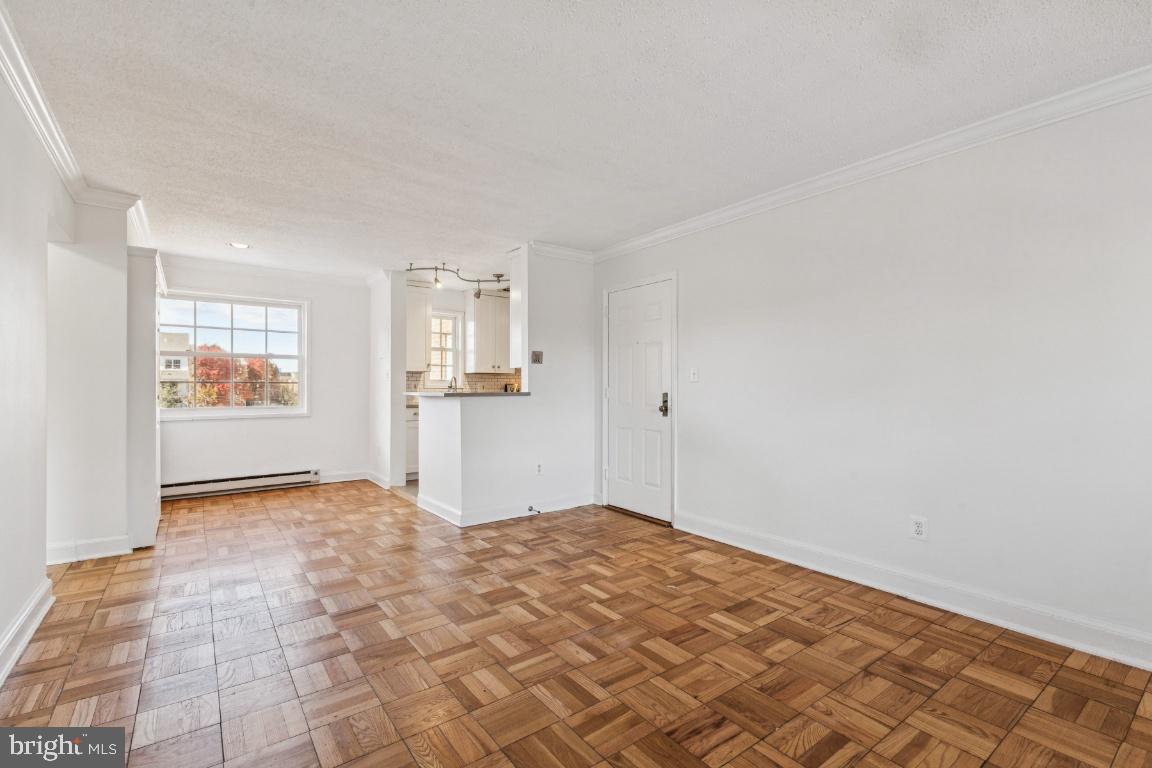 1620 West Abingdon Drive, Unit 301 Alexandria, VA 22314 - Photo 10 of 24 a view of empty room with wooden floor and windows