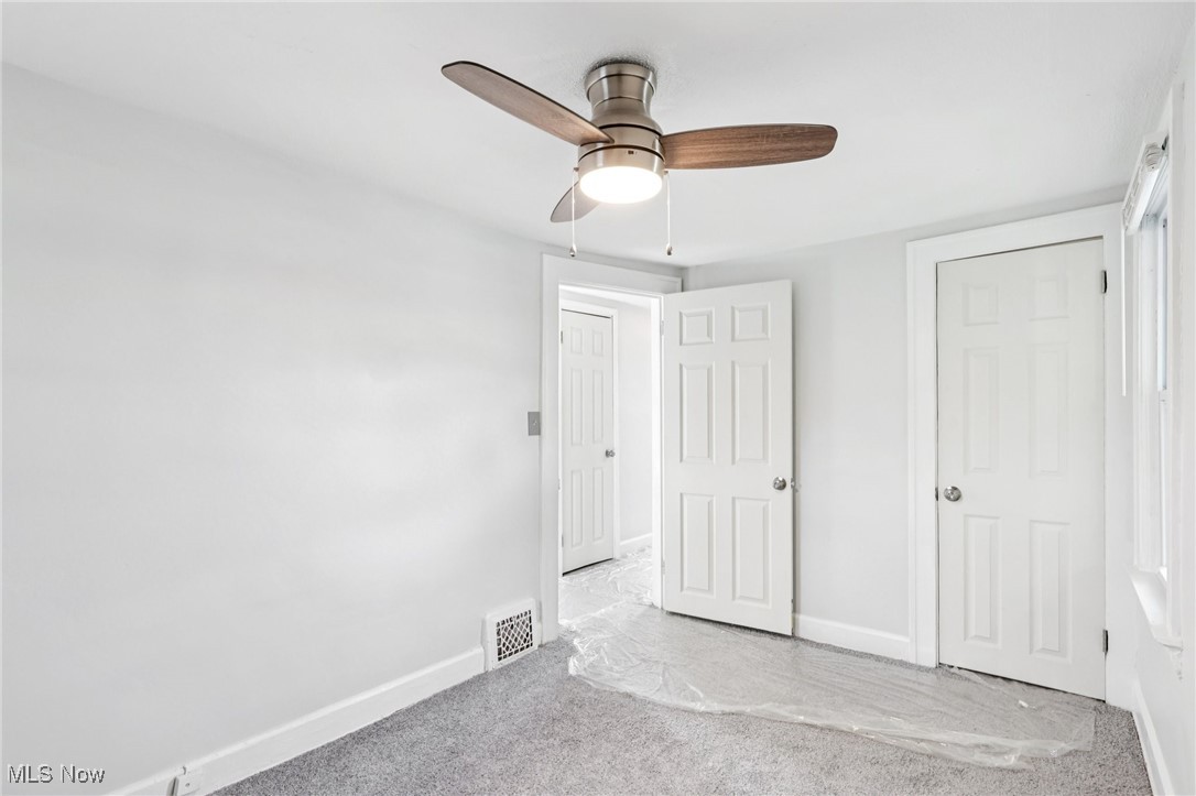 1469 South Noble Road Cleveland, OH 44121 - Photo 18 of 29 Unfurnished bedroom featuring carpet flooring and a ceiling fan