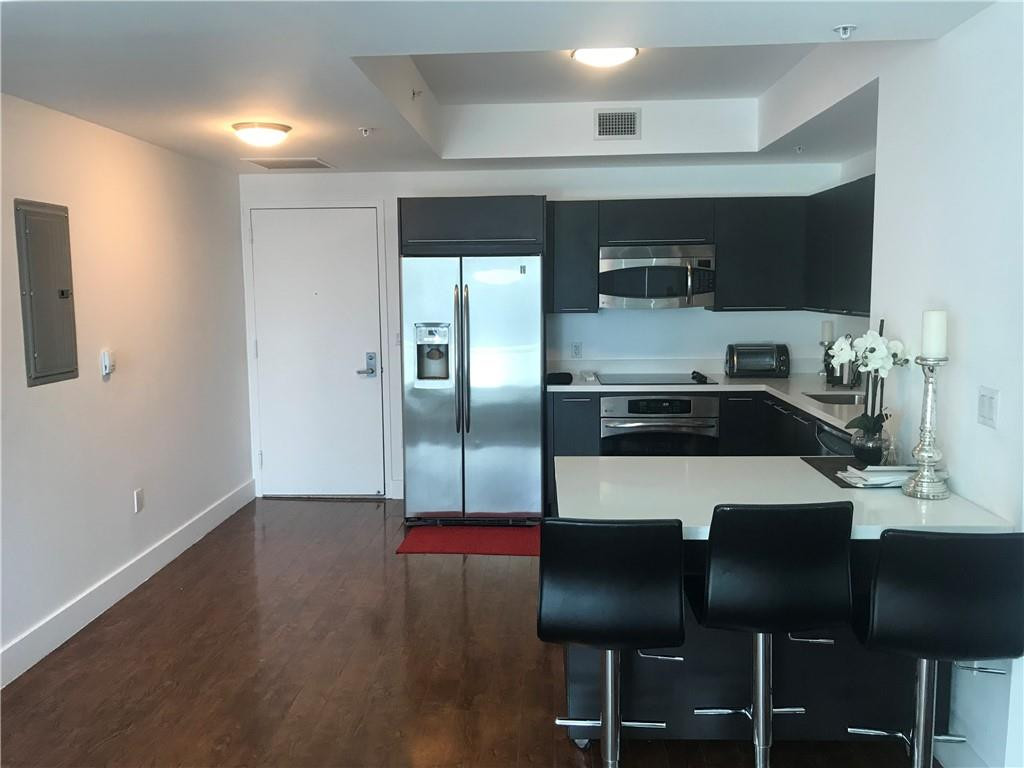 90 Southwest 3rd Street, Unit 1802 Miami, FL 33130 - Photo 1 of 50 a kitchen with stainless steel appliances granite countertop a sink dishwasher and a refrigerator