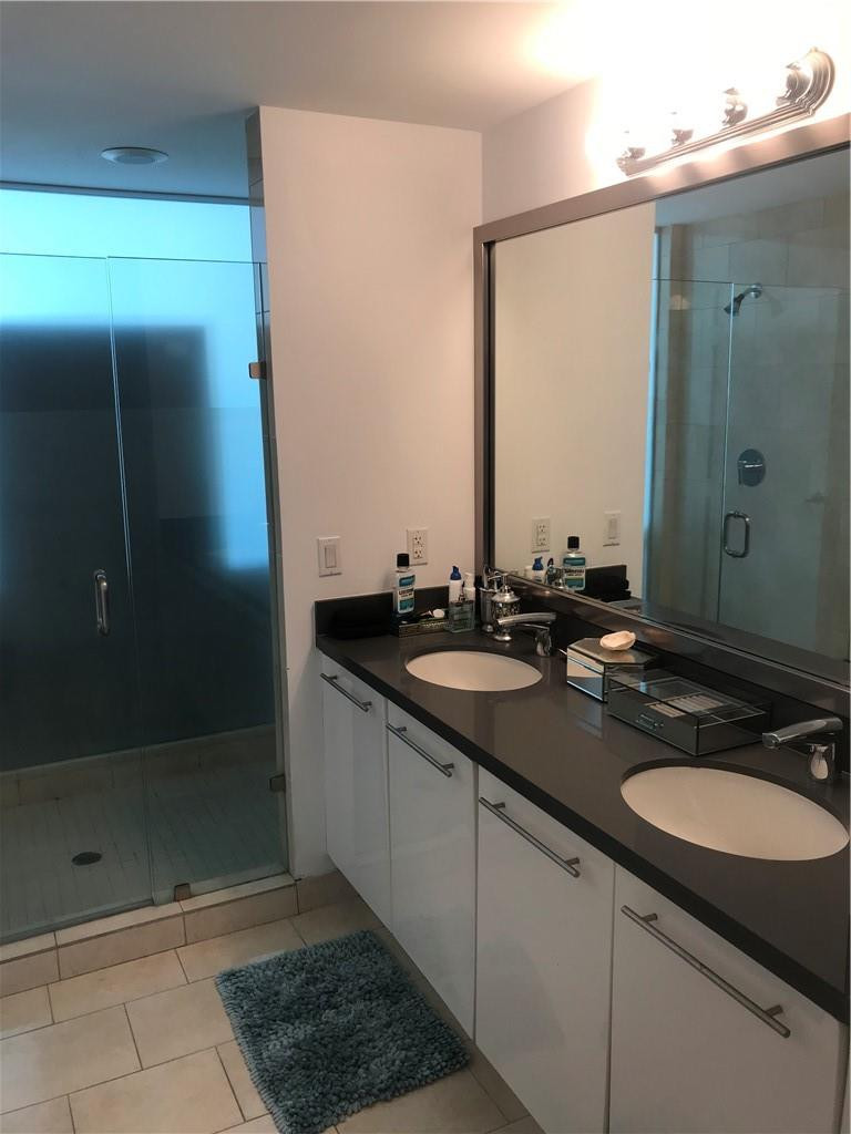 90 Southwest 3rd Street, Unit 1802 Miami, FL 33130 - Photo 15 of 50 a bathroom with a shower sink and mirror