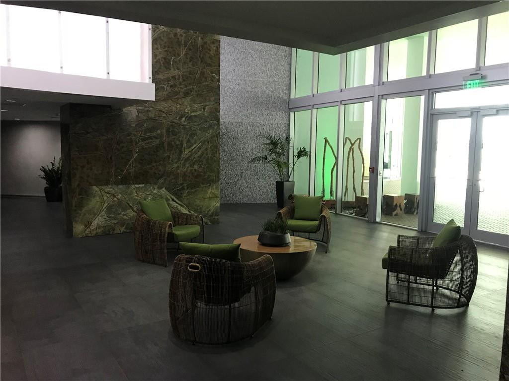 90 Southwest 3rd Street, Unit 1802 Miami, FL 33130 - Photo 26 of 50 a living room with furniture and a floor to ceiling window