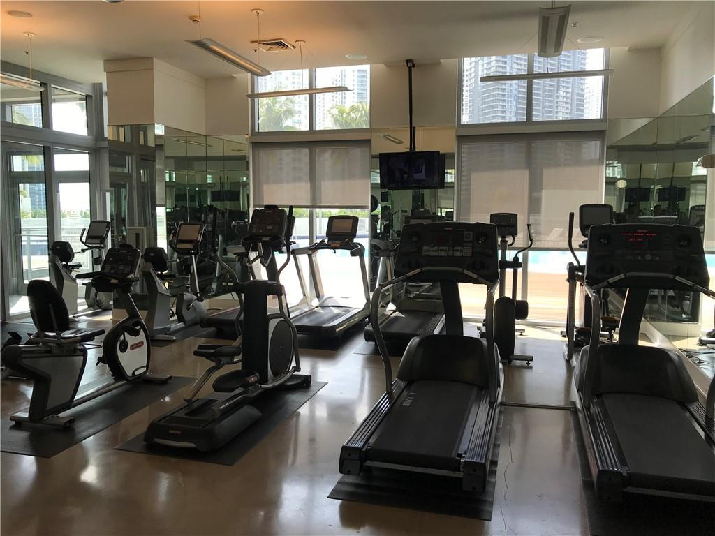 90 Southwest 3rd Street, Unit 1802 Miami, FL 33130 - Photo 28 of 50 a room with gym equipment and a large window