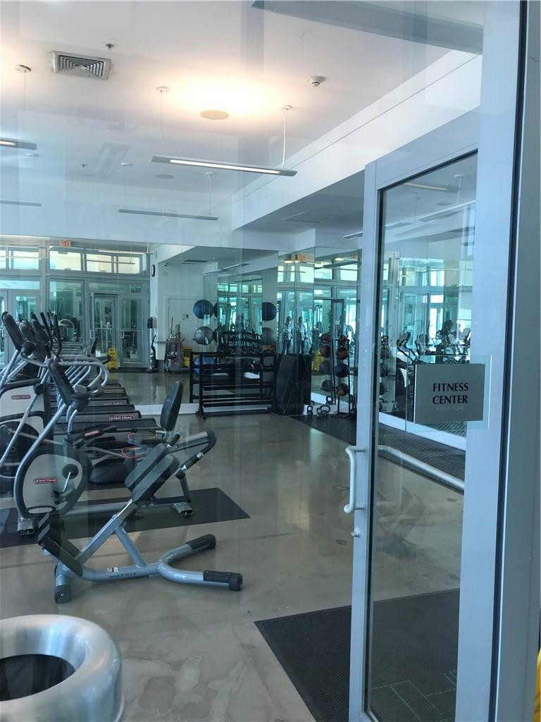 90 Southwest 3rd Street, Unit 1802 Miami, FL 33130 - Photo 29 of 50 a room with lots of chairs and mirrors