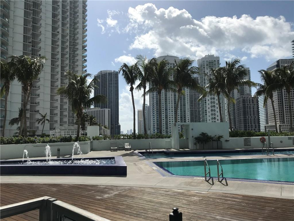 90 Southwest 3rd Street, Unit 1802 Miami, FL 33130 - Photo 30 of 50 a view of a house with a swimming pool and a chair