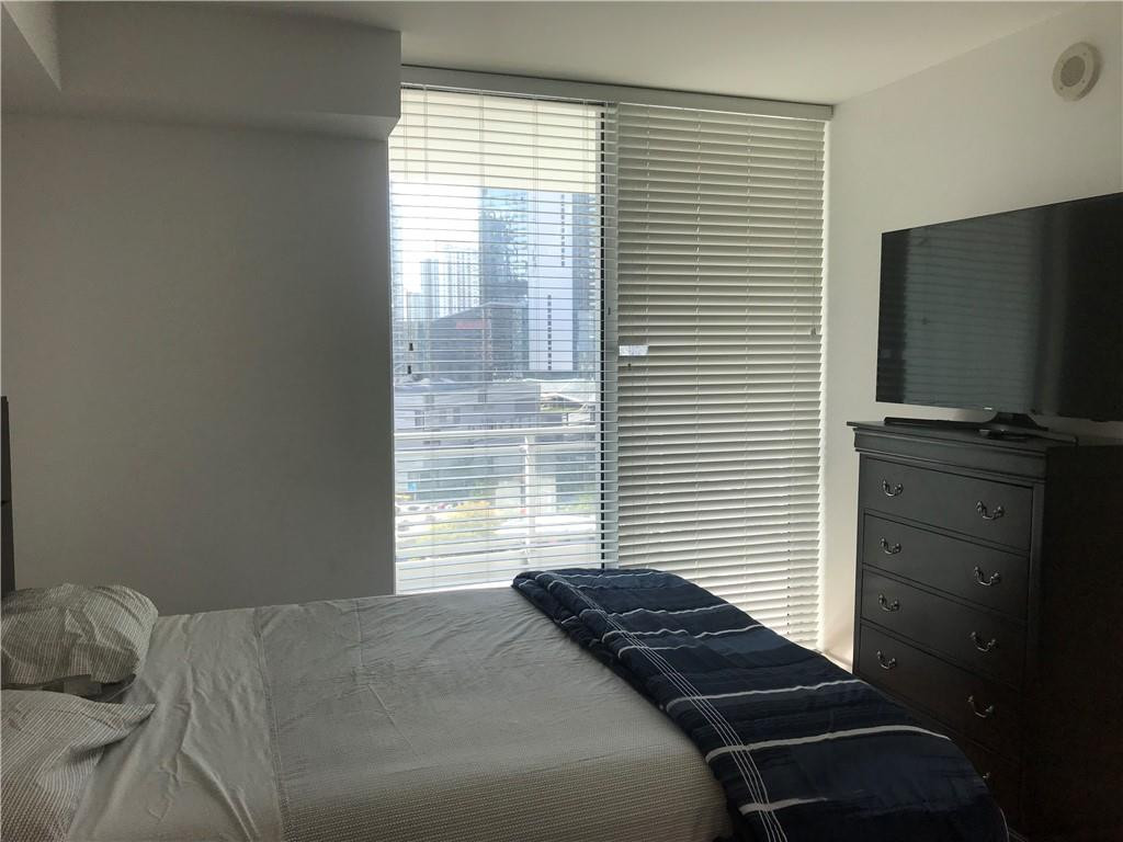 90 Southwest 3rd Street, Unit 1802 Miami, FL 33130 - Photo 7 of 50 a bedroom with a bed and a television