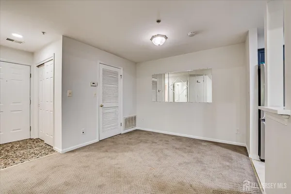 a view of kitchen with refrigerator and window
