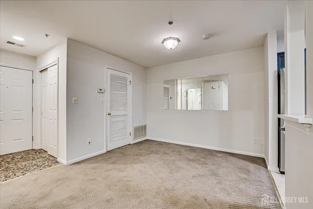 a view of kitchen with refrigerator and window
