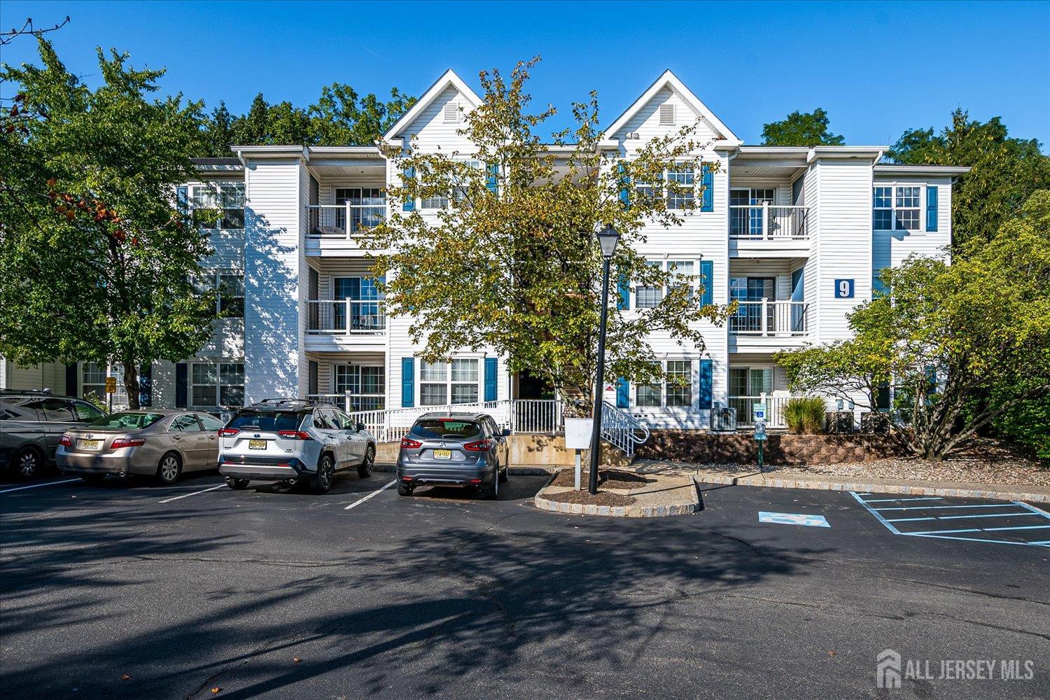 936 Waterford Drive Edison, NJ 08817 - Photo 2 of 29 a city street lined with buildings and cars