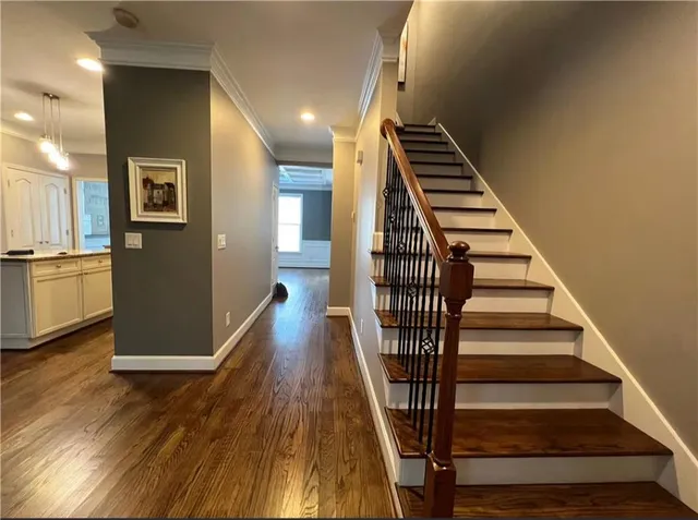 a view of entryway and hall with wooden floor