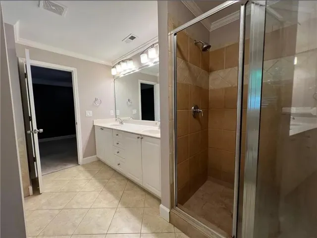 a spacious bathroom with a shower and a sink