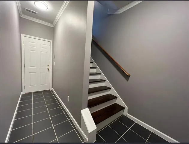 a view of an empty room with stairs