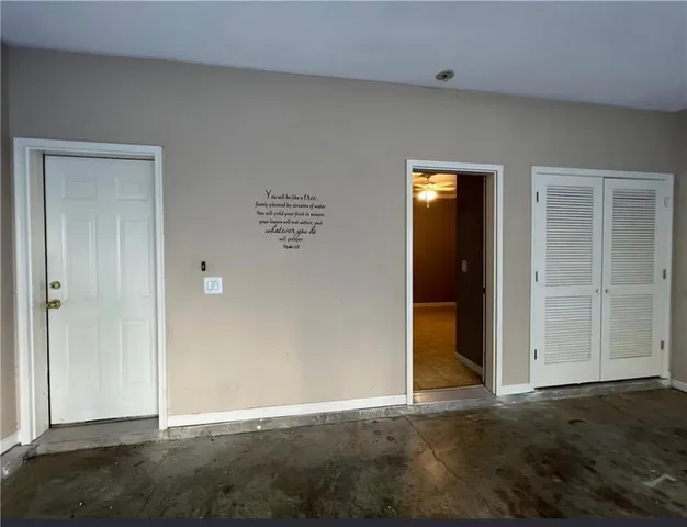 an empty room with windows and closet