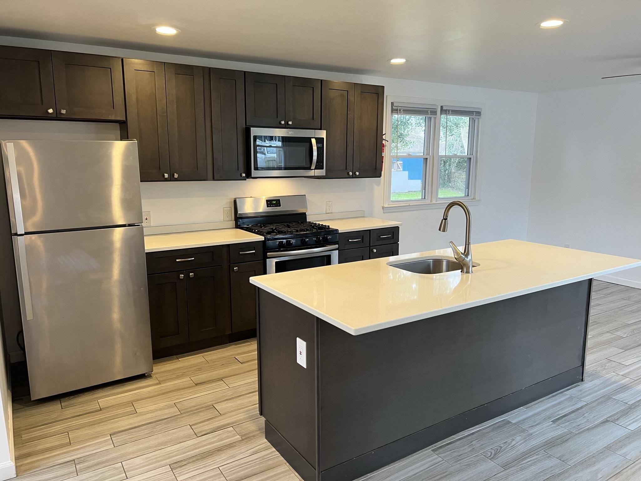 201 Linden Lane Rio Grande, NJ 08242 - Photo 7 of 18 a kitchen with sink a refrigerator and cabinets