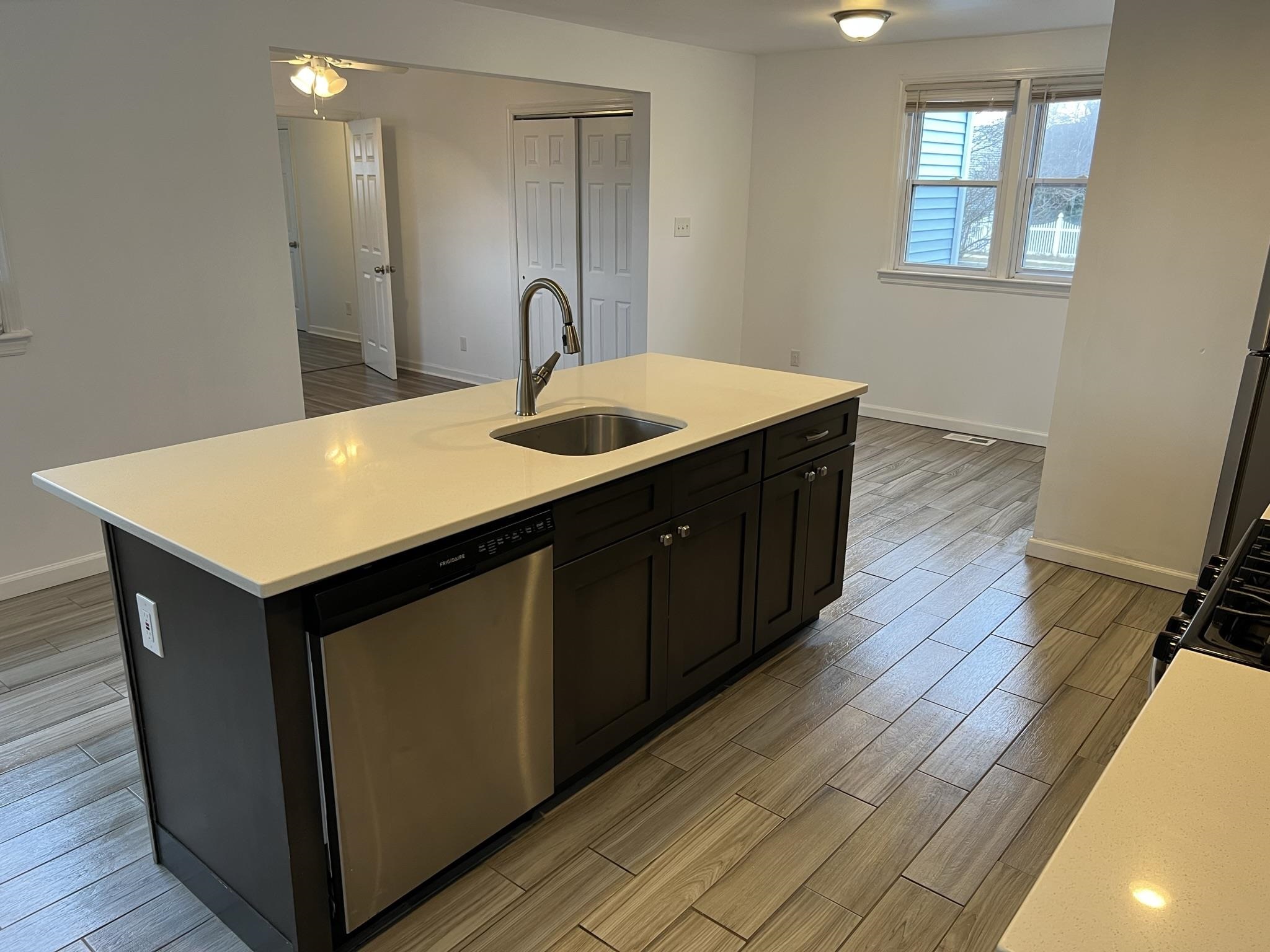 201 Linden Lane Rio Grande, NJ 08242 - Photo 8 of 18 a kitchen with a sink a mirror and wooden floor