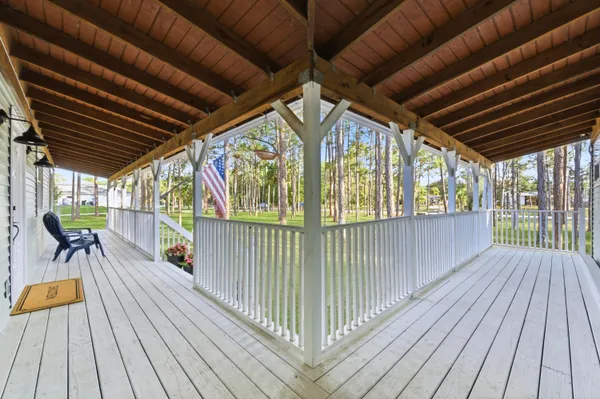 a view of a porch with furniture and chandelier
