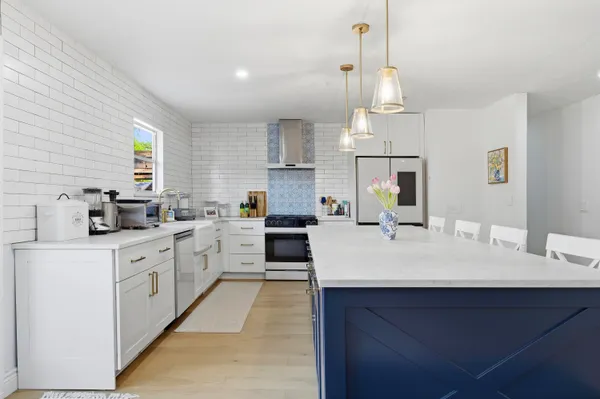 a living room with furniture and kitchen view