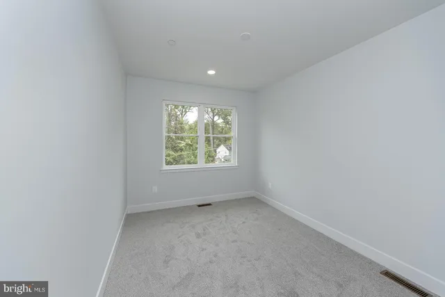 a view of room with wooden floor and windows