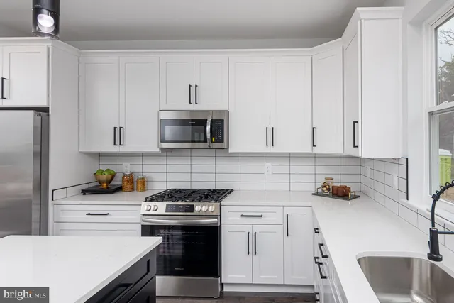 a view of kitchen with table and chairs