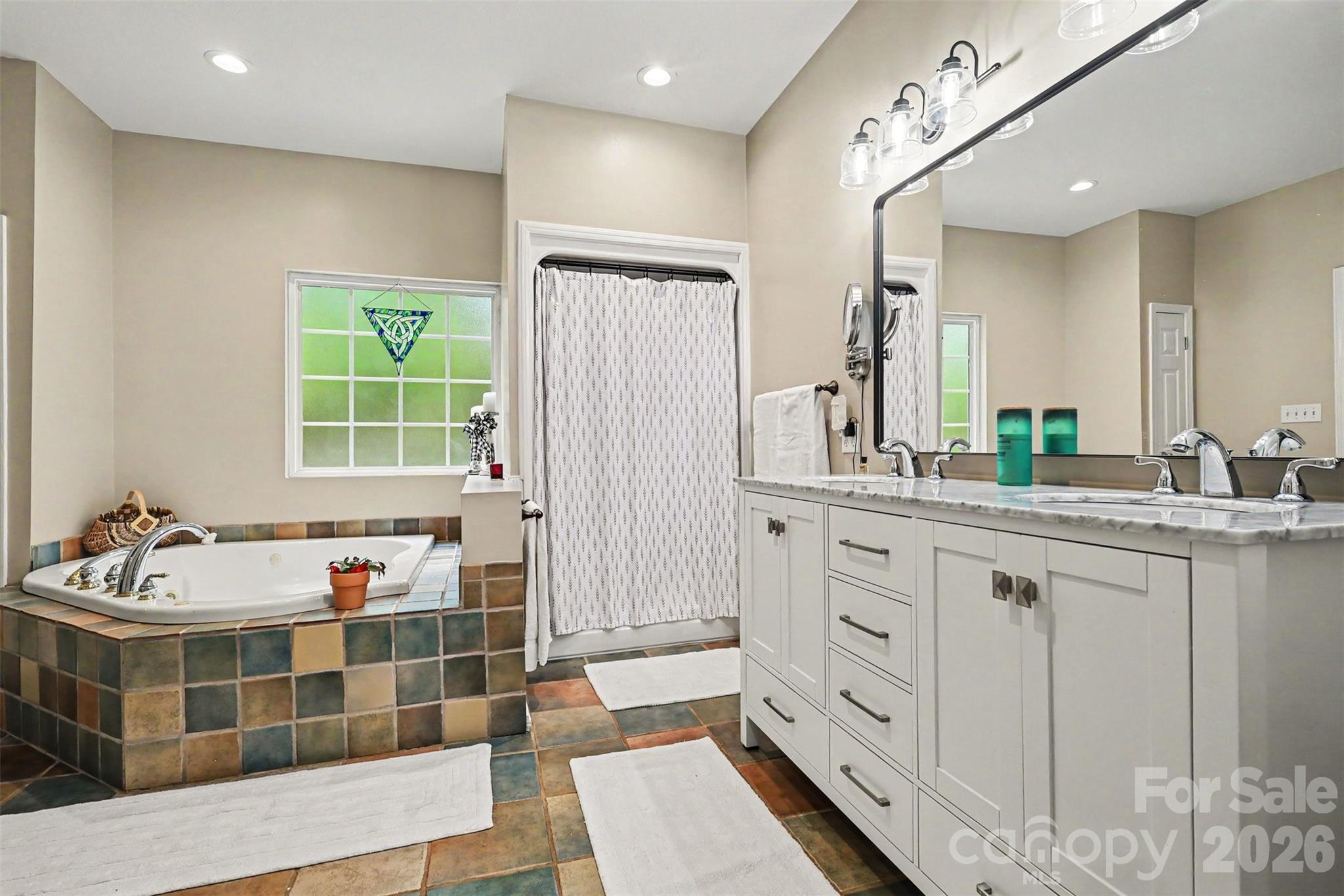 4037 Old Williamston Road Belton, SC 29627 - Photo 23 of 41 a spacious bathroom with double vanity sinks a mirror and a bathtub