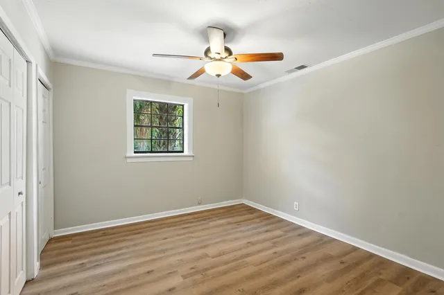 wooden floor in an empty room with a window