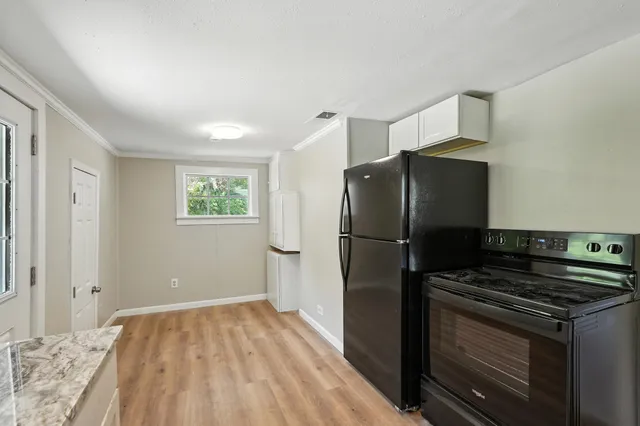 a kitchen with a refrigerator and a stove