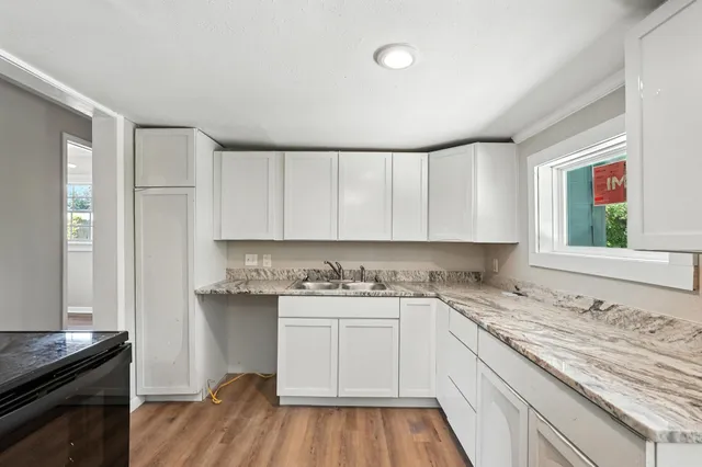 a kitchen with a sink stove and cabinets
